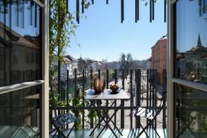 a table on a balcony with a view of a street at Zlata Ladjica Boutique Hotel in Ljubljana