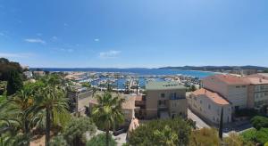 a view of a city with buildings and a harbor at Vue mer exceptionnelle in Le Lavandou