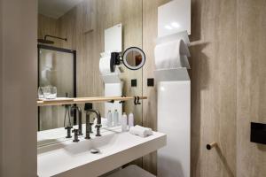 a bathroom with a sink and a mirror at Zlata Ladjica Boutique Hotel in Ljubljana