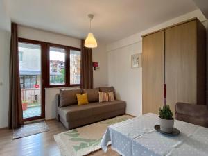 a living room with a couch and a table at Sunset Apartment in Struga