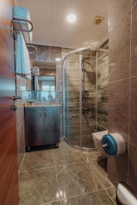 a bathroom with a shower and a sink and a toilet at Empula Hotel & Residences in Trabzon +170 photos