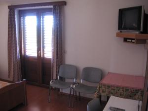 TV a/nebo společenská místnost v ubytování Guest House Caterina