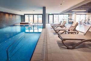 a swimming pool with chairs in a building at Antwell Suites in Istanbul