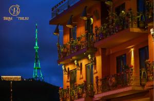 a view of the eiffel tower at night at Brim Hotel in Tbilisi City +79 photos