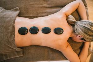 a woman laying on a couch with circles on her back at Insel der Sinne in Görlitz