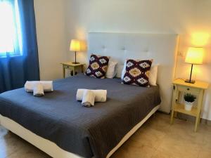 a bedroom with a large bed with pillows on it at Âncora Boutique Apartments in Lagos +37 photos