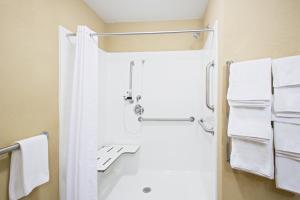 a bathroom with a shower, toilet, and sink at Candlewood Suites Pittsburgh-Cranberry, an IHG Hotel in Cranberry Township