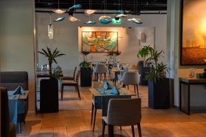 a restaurant with tables and chairs and a painting on the wall at Antwell Suites in Istanbul