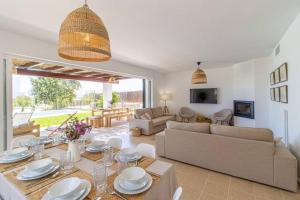 a living room with a table and a couch at Villa Conguitos in Sant Lluis
