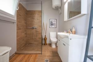 La salle de bains est pourvue d'une douche, de toilettes et d'un lavabo. dans l'établissement Lazaris Apartments, à Plage d'Almiros