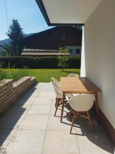 a wooden table and chairs on a patio at Appartementhaus Lisa in Afritz