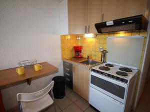 a small kitchen with a stove and a sink at Studio Les Saisies, 1 pièce, 3 personnes - FR-1-293-3 in Les Saisies