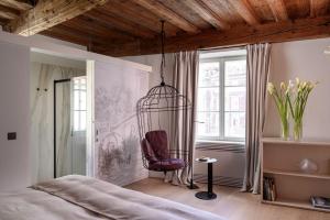 a bedroom with a chair in a cage at Zlata Ladjica Boutique Hotel in Ljubljana