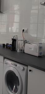 a kitchen with a washing machine on a counter at Apartamentos Leman in Benicarló