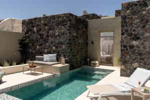a villa with a swimming pool and a patio at Mardanza Exclusive in Imerovigli