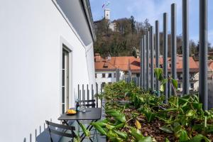 a balcony with chairs and plants on a building at Zlata Ladjica Boutique Hotel in Ljubljana
