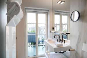 a bathroom with a sink and a mirror at Zlata Ladjica Boutique Hotel in Ljubljana