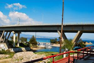 a bridge over a river with boats in the water at Canal Luxury Apartments in Nea Potidaea