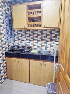 a kitchen with a sink and a counter top at Residence Sighaka - Gold Apartment - WiFi, Gardien, Parking in Douala