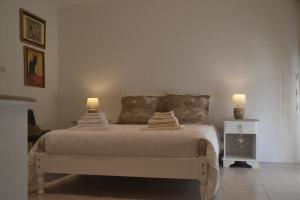 a bedroom with a bed with two lamps on it at Les chambres de la grange in Cherval