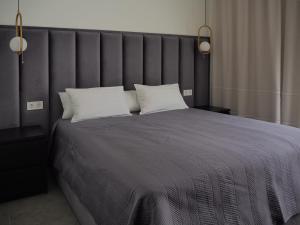 a bedroom with a large bed with two white pillows at Villa with magnificants sea views on Cullera bay. in Faro de Cullera