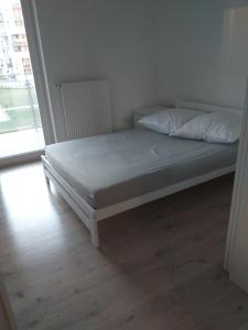 a bed in a room with a white bed frame at Apartament RUCZAJ in Lublin