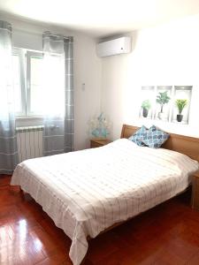 a bedroom with a large white bed in a room at Villa Magica in Pirovac