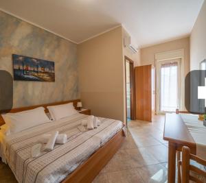 a bedroom with a large bed in a room at Bed & breakfast Tre Palme in Raffadali +4 photos