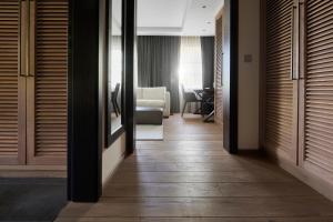 a corridor of a hotel room with wooden doors at Margarethenhof am Tegernsee in Waakirchen