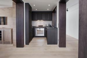 a kitchen with black cabinets and a counter top at Margarethenhof am Tegernsee in Waakirchen