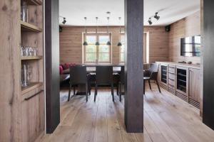 a kitchen and dining room with a table and chairs at Margarethenhof am Tegernsee in Waakirchen