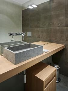a bathroom with a concrete sink and a mirror at Margarethenhof am Tegernsee in Waakirchen