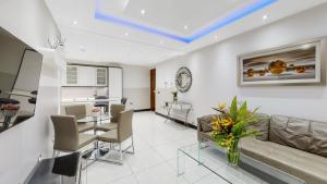 a living room with a couch and a table at Bryanston Apartments in London