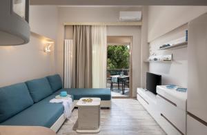 a living room with a blue couch and a table at Villa Sara in Nikiti