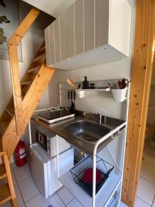 a small kitchen with a sink and a stove at LA GRAA in Piuro