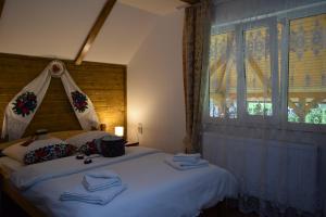 a bedroom with a bed with towels on it at Casa Leca in Breb +116 photos