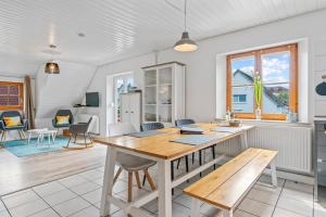 a kitchen and living room with a table and chairs at TTP Apartments Immenstaad in Immenstaad am Bodensee