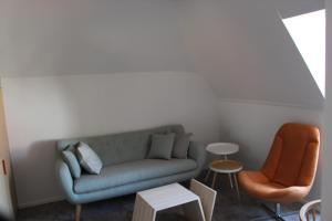 a living room with a couch and two chairs at Hotel Le Bois De Bruges in Bruges