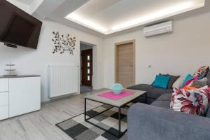 a living room with a couch and a table at Apartman Milan in Banjole