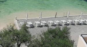 a group of chairs sitting on a beach at Olea in Tivat