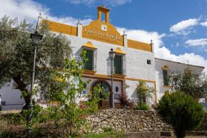 a building with a sign on the side of it at Caserio de Iznájar in Iznájar