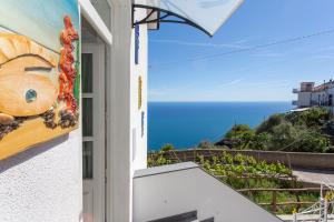 vistas al océano desde el balcón de una casa en Holidays Perla d'Amalfi, en Amalfi