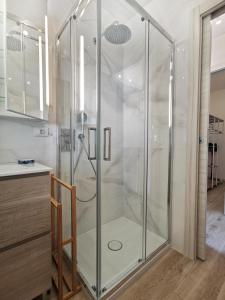 a shower with a glass door in a bathroom at Casa Pina in Tignale