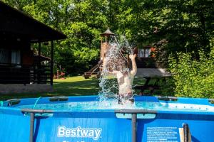 a young boy playing in a water fountain at The Hideaway in Želiv