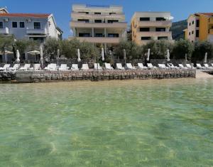 a group of chairs and tables in the water at Olea in Tivat