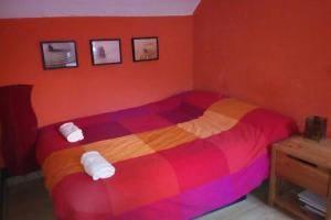 a bedroom with a colorful bed with towels on it at 202A Ático con encanto - Centro de Villaviciosa in Villaviciosa