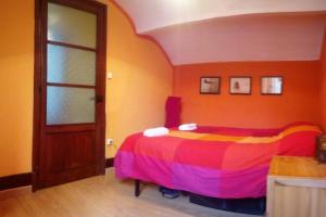 1 dormitorio con 1 cama con colcha colorida en 202A Ático con encanto - Centro de Villaviciosa, en Villaviciosa