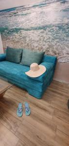 a blue couch with a hat and flip flops at Old Town Residence in Constanţa