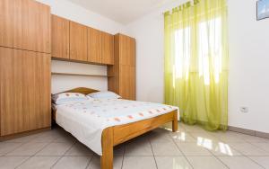 Postel nebo postele na pokoji v ubytování Apartman Justinić