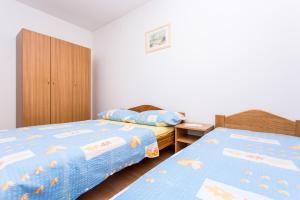 Posteľ alebo postele v izbe v ubytovaní Apartman Justinić